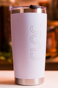 White tumbler with 'RUNR' branding on a blurred background