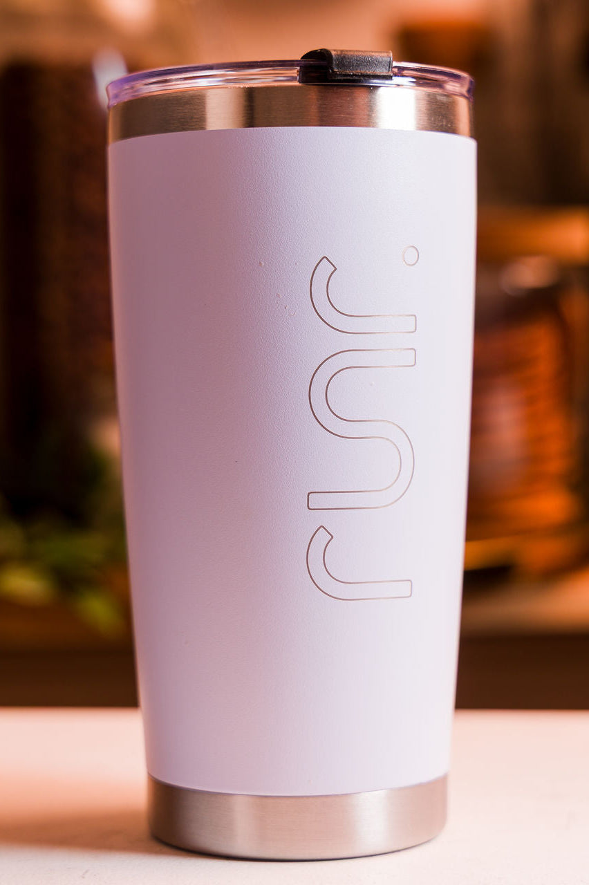 White tumbler with 'RUNR' branding on a blurred background